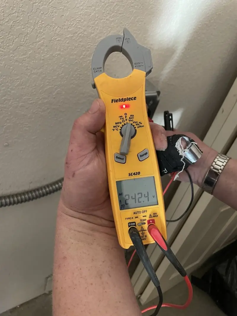 Voltage testing with clamp meter during Whole House Surge Protector in Topeka